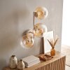 Retro Globe wall light Gastor with three clustered amber and clear glass shades