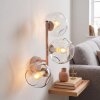 Modern globe wall light Ripoll with three clear glass shades in vertical arrangement