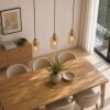 Brilliant Linear Pendant Light Lyska for kitchen islands, with 3 amber glass shades